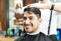 Smart Client Smiling While Stylist Cutting His Hair In Salon