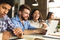 Smart college students networking on laptop in library Royalty Free Stock Photo