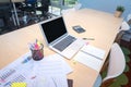 Smart computer and document put on wooden table in Co Working Space