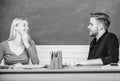 Smart and confident. Teacher and schoolmaster sitting at desk. Handsome man and pretty woman back to school. University Royalty Free Stock Photo