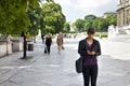 Smart and confident young woman striding through urban area