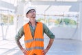 Smart construction engineer worker architect. Builder foreman work in construction site standing checking building workplace Royalty Free Stock Photo