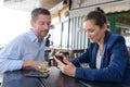 smart couple in cafe woman using smartphone Royalty Free Stock Photo
