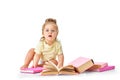 Smart, curious baby. Little girl, toddler sitting on floor with many books around against white studio background Royalty Free Stock Photo