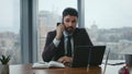 Smart director talking mobile phone sitting desk with laptop close up. Work call Royalty Free Stock Photo