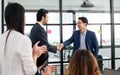 Smart diverse business people wearing formal suits, smiling with happiness, success, making handshake to deal business agreement Royalty Free Stock Photo