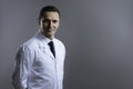Smart doctor looking serious on a grey background Royalty Free Stock Photo
