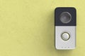 Smart doorbell on yellow wall Royalty Free Stock Photo