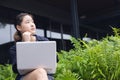 Smart eastern asian young new generation business women thinking projects creative outdoors with laptop computer Royalty Free Stock Photo