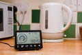 Smart energy meter in a home interior to monitor electricity usage in the house and reduce cost of living price Royalty Free Stock Photo