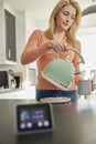 Smart Energy Meter In Kitchen Measuring Electricity And Gas Use With Woman Boiling Kettle Royalty Free Stock Photo