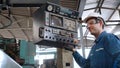 Smart factory worker using machine in factory workshop Royalty Free Stock Photo