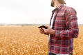 Smart farming using modern technologies in agriculture. Man agronomist farmer with digital tablet computer in wheat