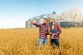 Smart farming using modern technologies in agriculture. Man agronomist farmer with digital tablet computer in wheat Royalty Free Stock Photo