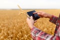 Smart farming using modern technologies in agriculture. Man agronomist farmer with digital tablet computer in wheat Royalty Free Stock Photo