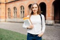 Smart female college student with bag and books on campus outdoors Royalty Free Stock Photo