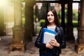 Young smart female college student on campus outdoors