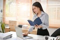 Smart and focused Asian businesswoman working on her business assignment at her desk Royalty Free Stock Photo