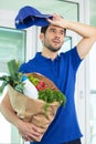 smart food delivery service man in uniform tired Royalty Free Stock Photo