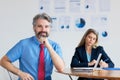 Smart german businessman with grey hair and computer