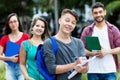 Smart german male student with group of other students