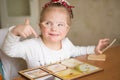 Smart girl with Down syndrome collects puzzles