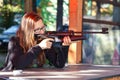 Smart girl shooting from air gun Royalty Free Stock Photo