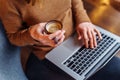 A smart girl siting and working in the office with a laptop and a cup of aromatic espresso  cappuccino. Holding a laptop on her Royalty Free Stock Photo