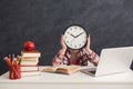 Cute smart girl holding clock covering fave Royalty Free Stock Photo