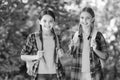 Smart girls. childhood hapiness. two sisters in school uniform outdoor. ready for holidays. happy teen kids carry Royalty Free Stock Photo