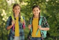 Smart girls. childhood hapiness. two sisters in school uniform outdoor. ready for holidays. happy teen kids carry Royalty Free Stock Photo