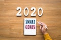 2020, smart goal concepts with notepad and male hand on wood background.Business challenge.Inspiration ideas Royalty Free Stock Photo