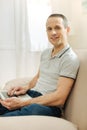 Smart handsome man smiling and holding a modern laptop Royalty Free Stock Photo