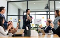 Smart happy businessman wearing formal suit, smiling with confidence, success, holding bottle of wine to celebrate his project Royalty Free Stock Photo