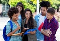 Smart hispanic female student learning with group of latin and african american young adults Royalty Free Stock Photo