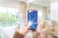 Smart home automation app on mobile with home interior in background. Internet of things concept at home. Smart technology 4.0 Royalty Free Stock Photo