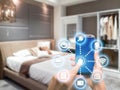 Smart home automation app on mobile with home interior in background. Internet of things concept at home. Smart technology 4.0 Royalty Free Stock Photo