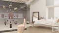 Smart home control concept, hand controlling digital interface from mobile app. Background showing loft open space with bedroom an