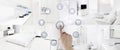 Smart home control concept hand touch icons screen with interiors, living room, kitchen, bedroom and bathroom on blurred