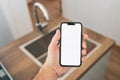 Smart home smartphone mockup screen in front of kitchen sink Royalty Free Stock Photo