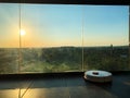 Smart House. Vacuum cleaner robot runs on floor in a living room.