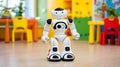 Smart humanoid robot standing in colorful classroom interior with bright chairs and tables modern education technology Royalty Free Stock Photo