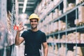 Smart Indian engineer man worker wearing safety helmet doing stocktaking of product management in cardboard box Royalty Free Stock Photo