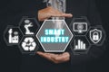 Person hand holding smart industry icon on virtual screen, AI, Artificial Intelligence, Automation robot arm, Smart factory Royalty Free Stock Photo