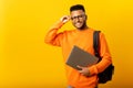Smart inteligente indian male employee or freelancer man holding laptop and looking at camera with happy smile, isolated
