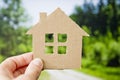 Child holds paper house. Loan for new house theme. Financial operations.