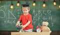 Smart kid concept. First former interested in studying, learning, education. Child on busy face near microscope. Kid boy