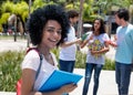 Smart latin american female student with group of students Royalty Free Stock Photo