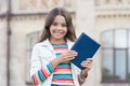 Smart library is open. Happy child hold library book outdoors. Little girl go to library. School library. Studying Royalty Free Stock Photo