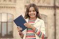 Smart library is open. Happy child hold library book outdoors. Little girl go to library. School library. Studying Royalty Free Stock Photo